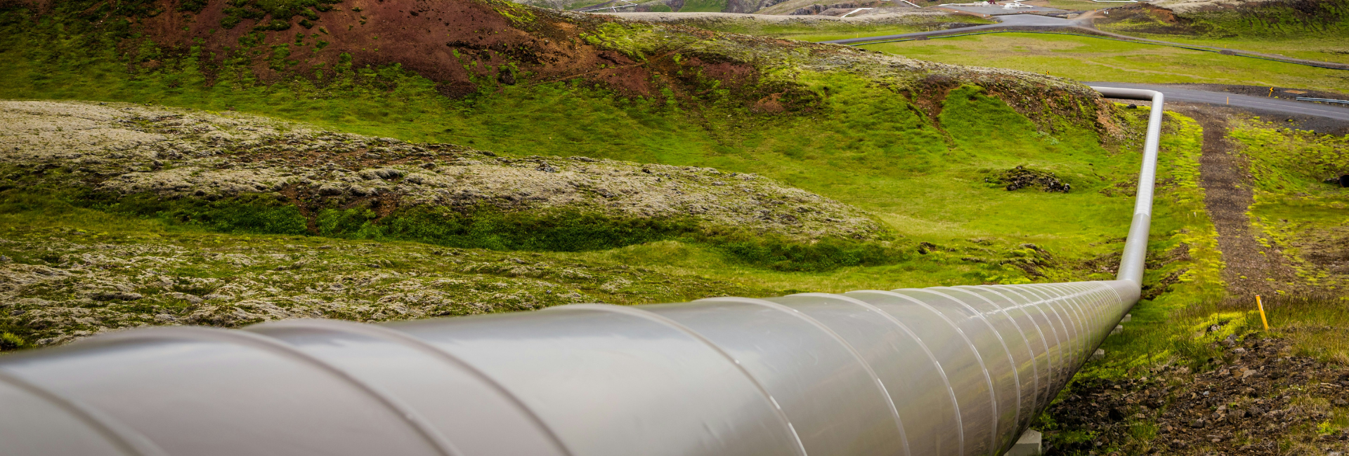 A large pipeline on a grassy hill