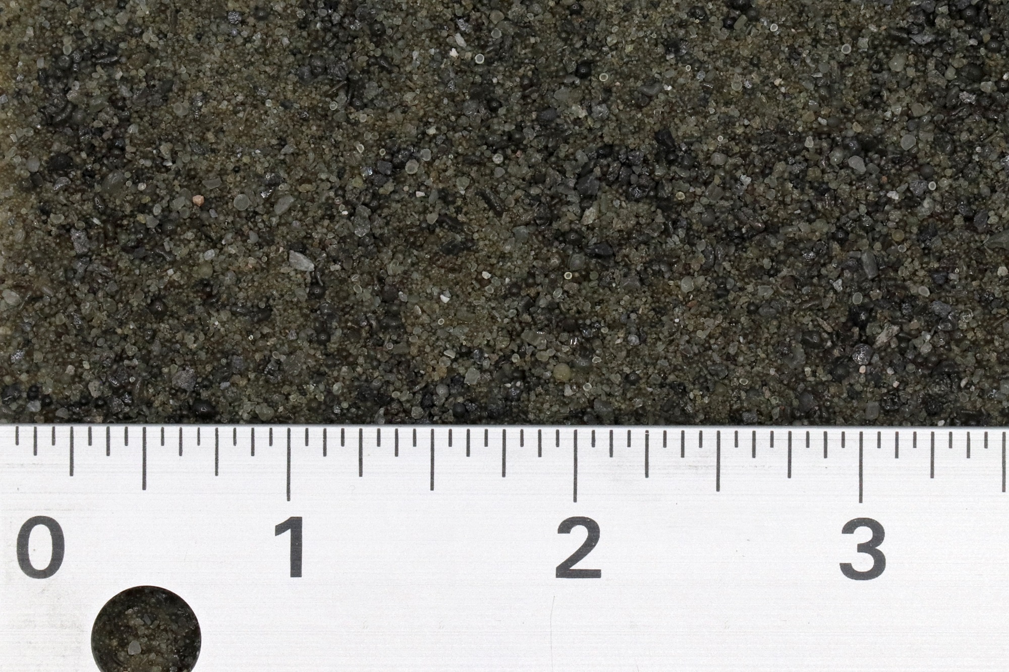 a ruler measures a abrasive media between 1 and 3 inches