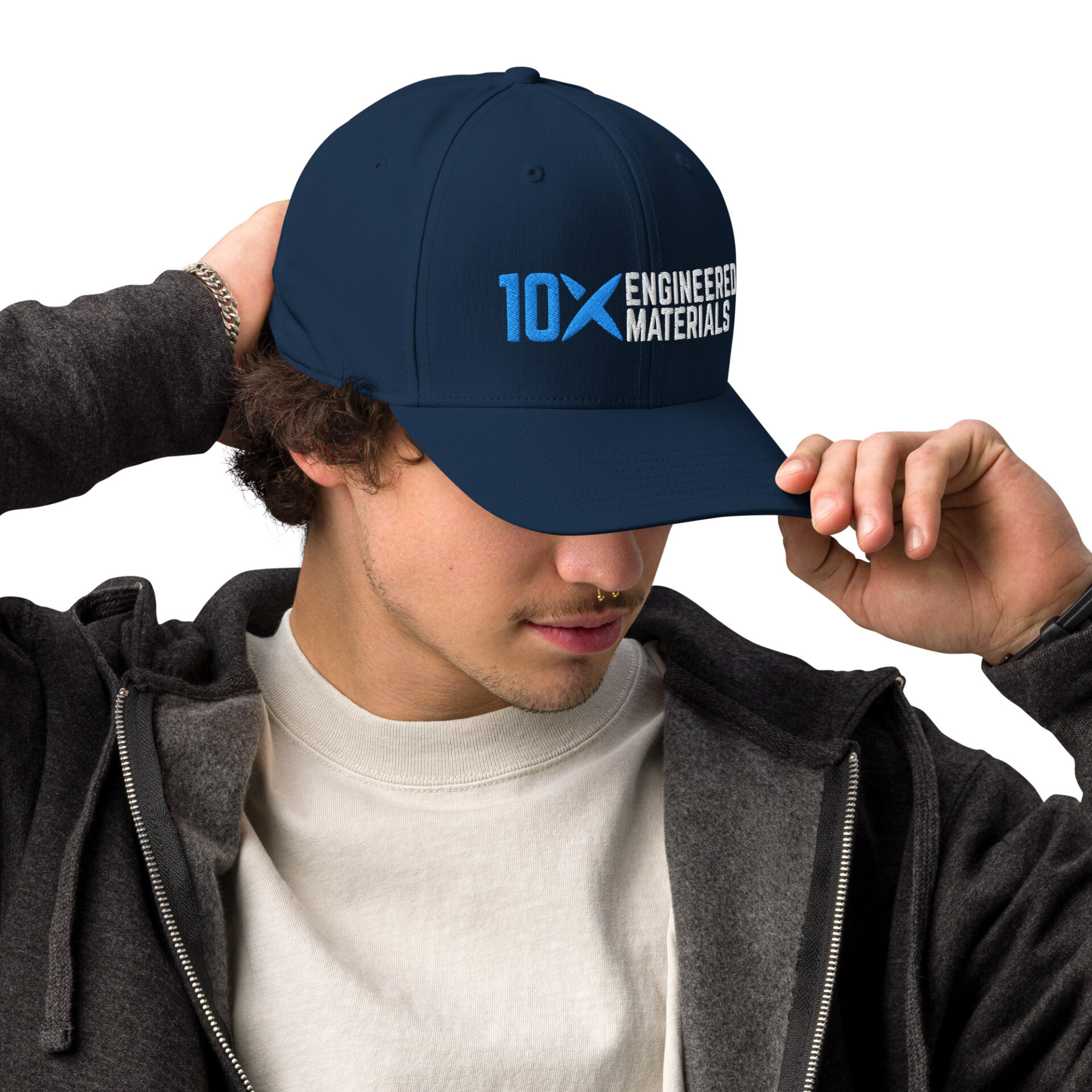A man wearing a navy blue hat that has the 10X Engineered Materials logo on it