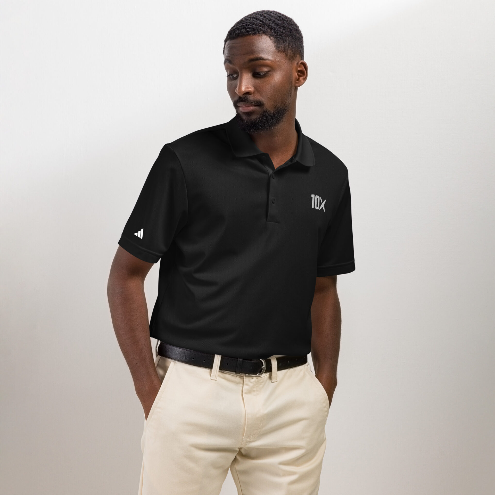 a man wearing a black adidas polo shirt with the 10X logo on it