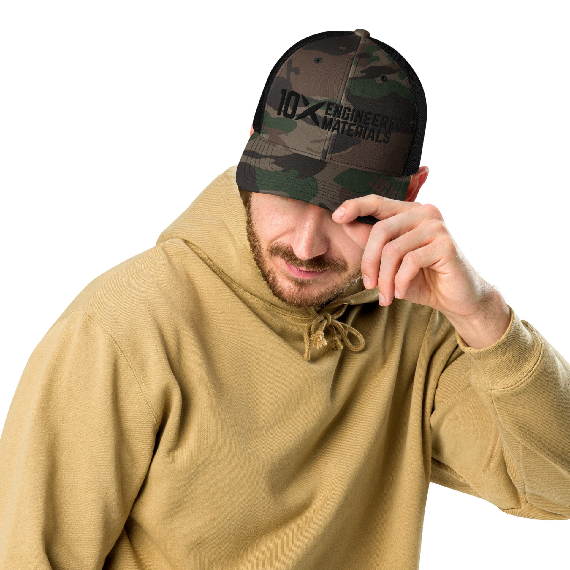 a man wearing a camo hat with a black 10X Engineered Materials logo on it