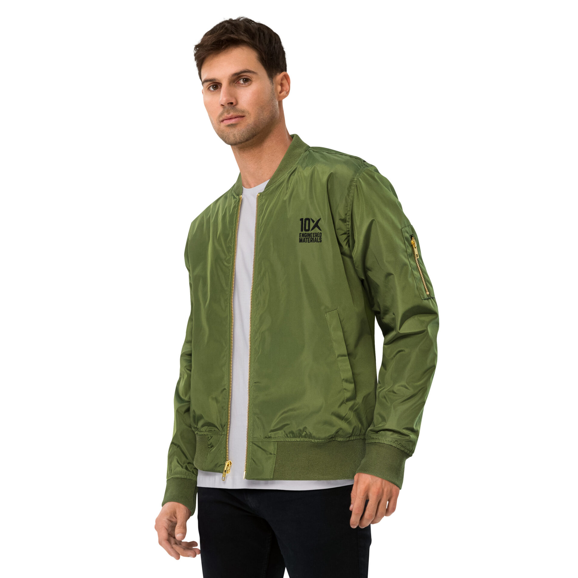 a man wearing a green bomber jacket that has the 10X Engineered Materials logo on it in black