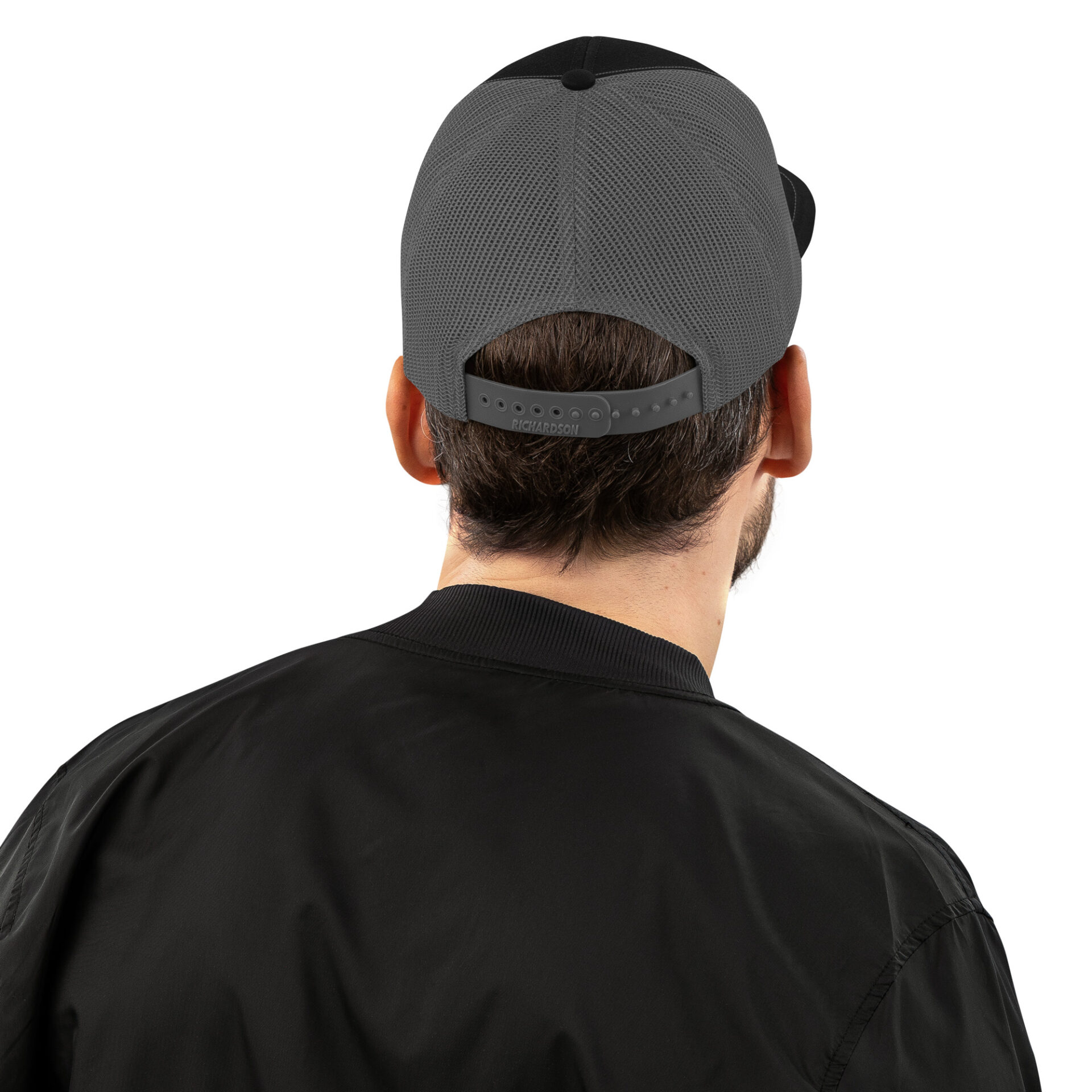 a man wearing a black bomber jacket and a grey hat