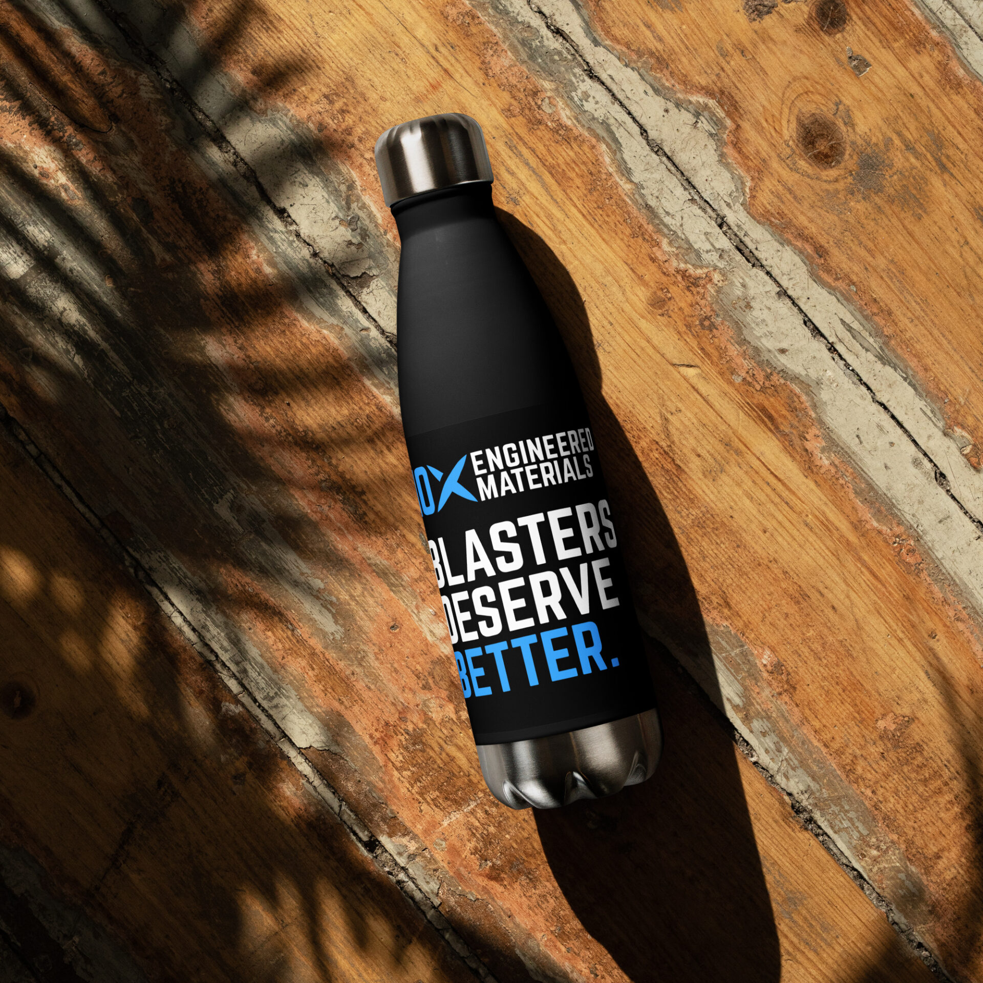 A black stainless steel water bottle that has the 10X logo on it and says "Blasters Deserve Better"