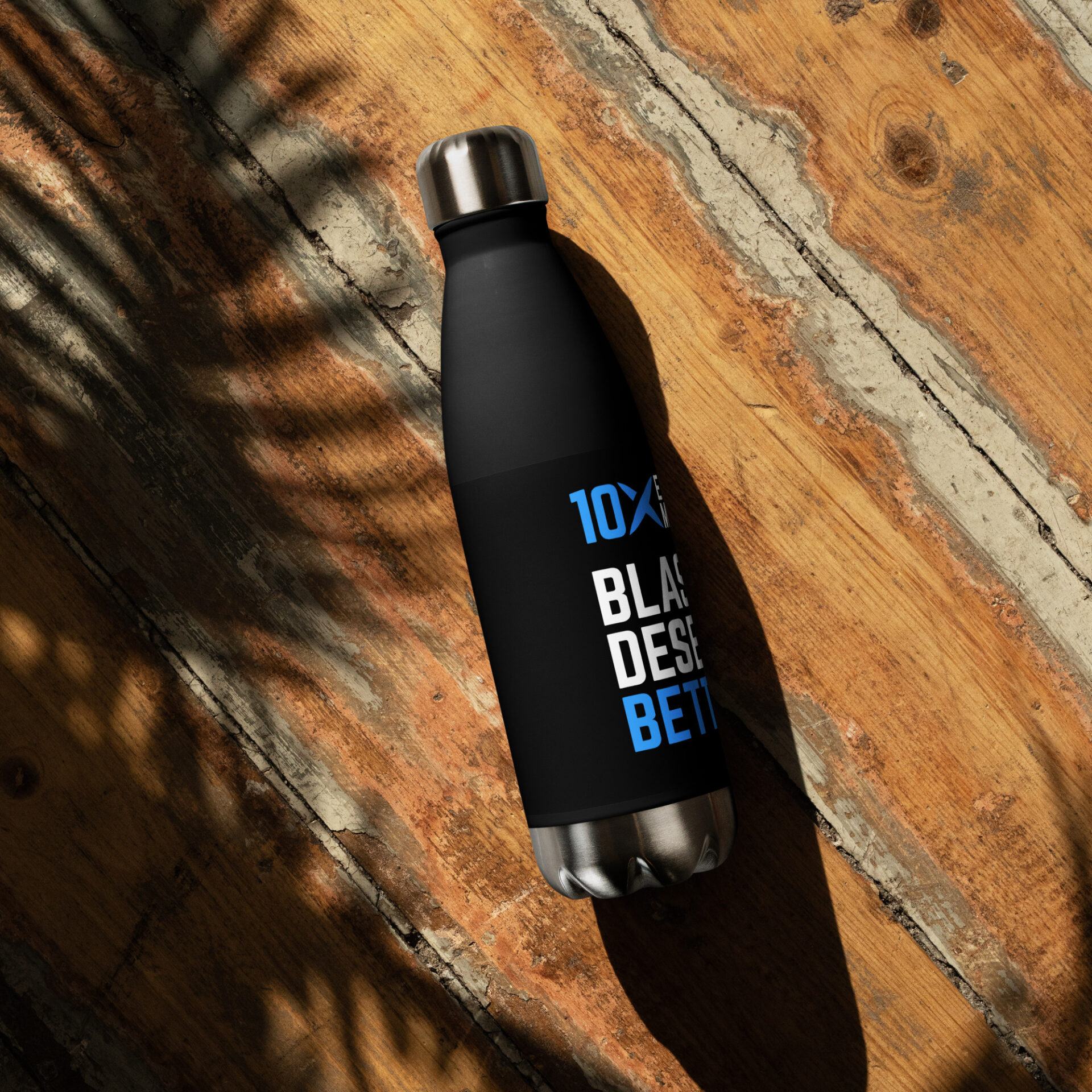 A black stainless steel water bottle that has the 10X logo on it and says "Blasters Deserve Better"