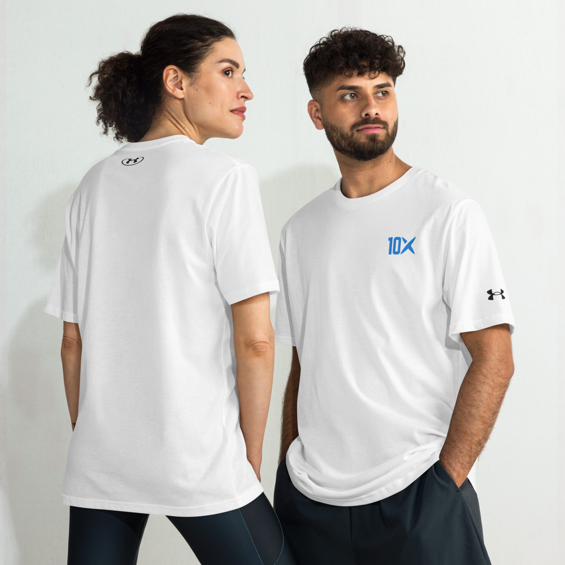 a man and a woman wearing white under armour shirts with the 10X logo on them in blue