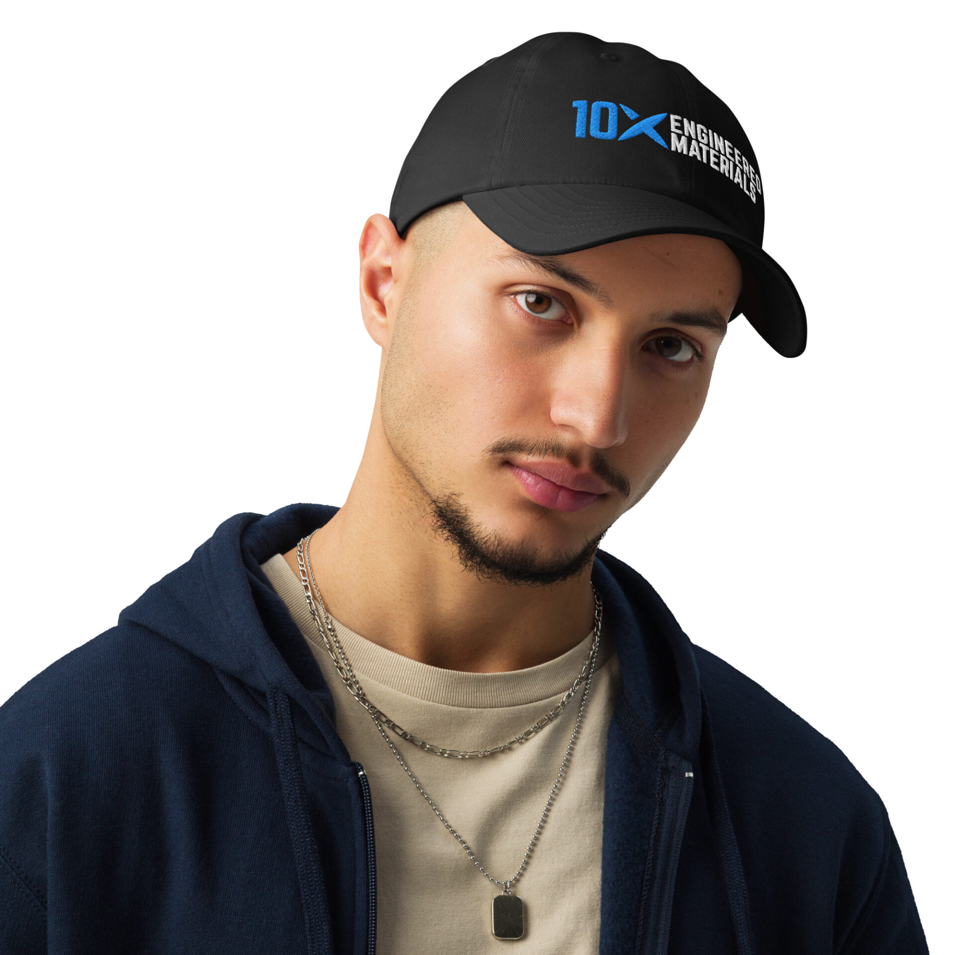 A man wearing a black hat that has the 10X Engineered Materials logo on it