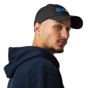 A man wearing a black hat that has the 10X Engineered Materials logo on it