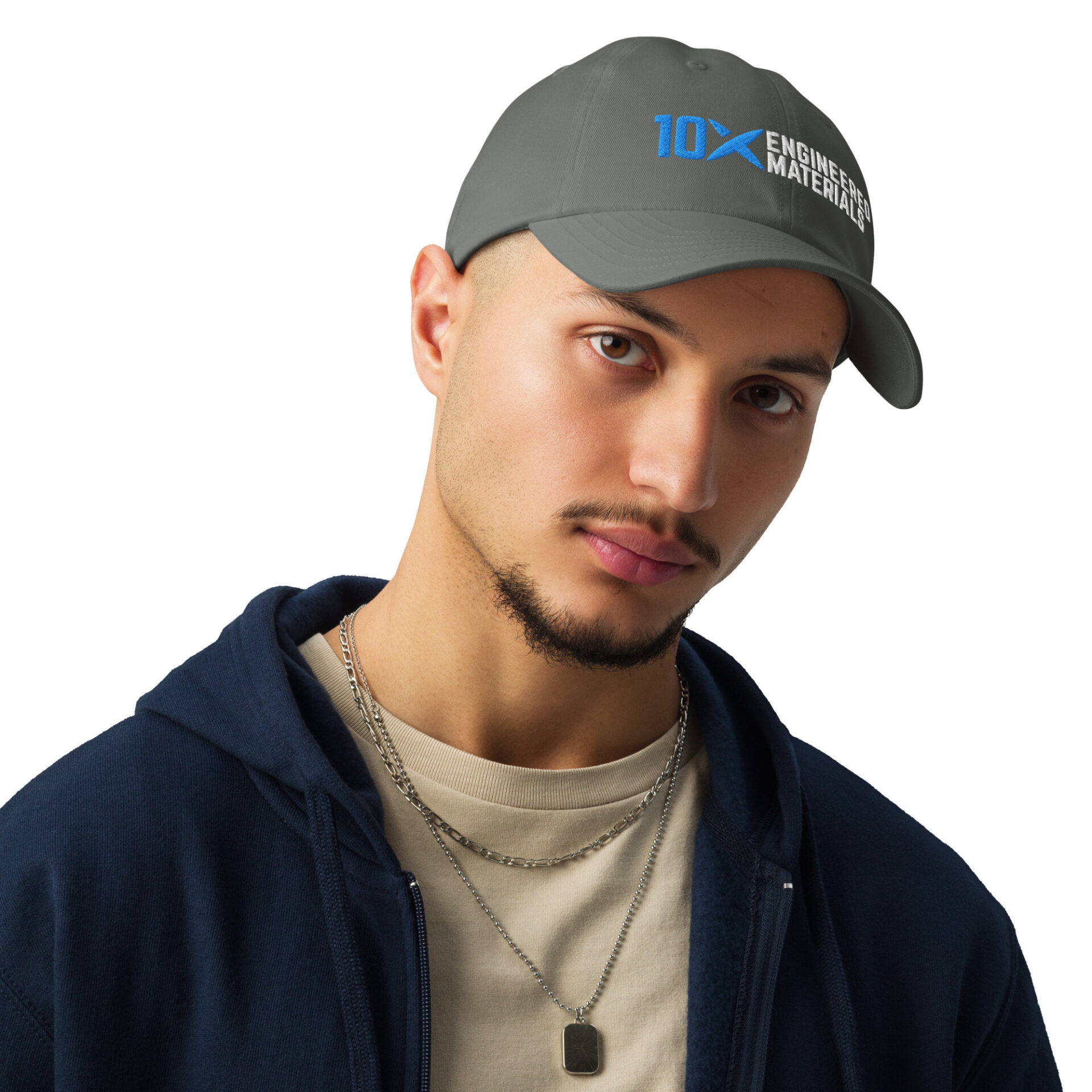 A man wearing a grey hat that has the 10X Engineered Materials logo on it