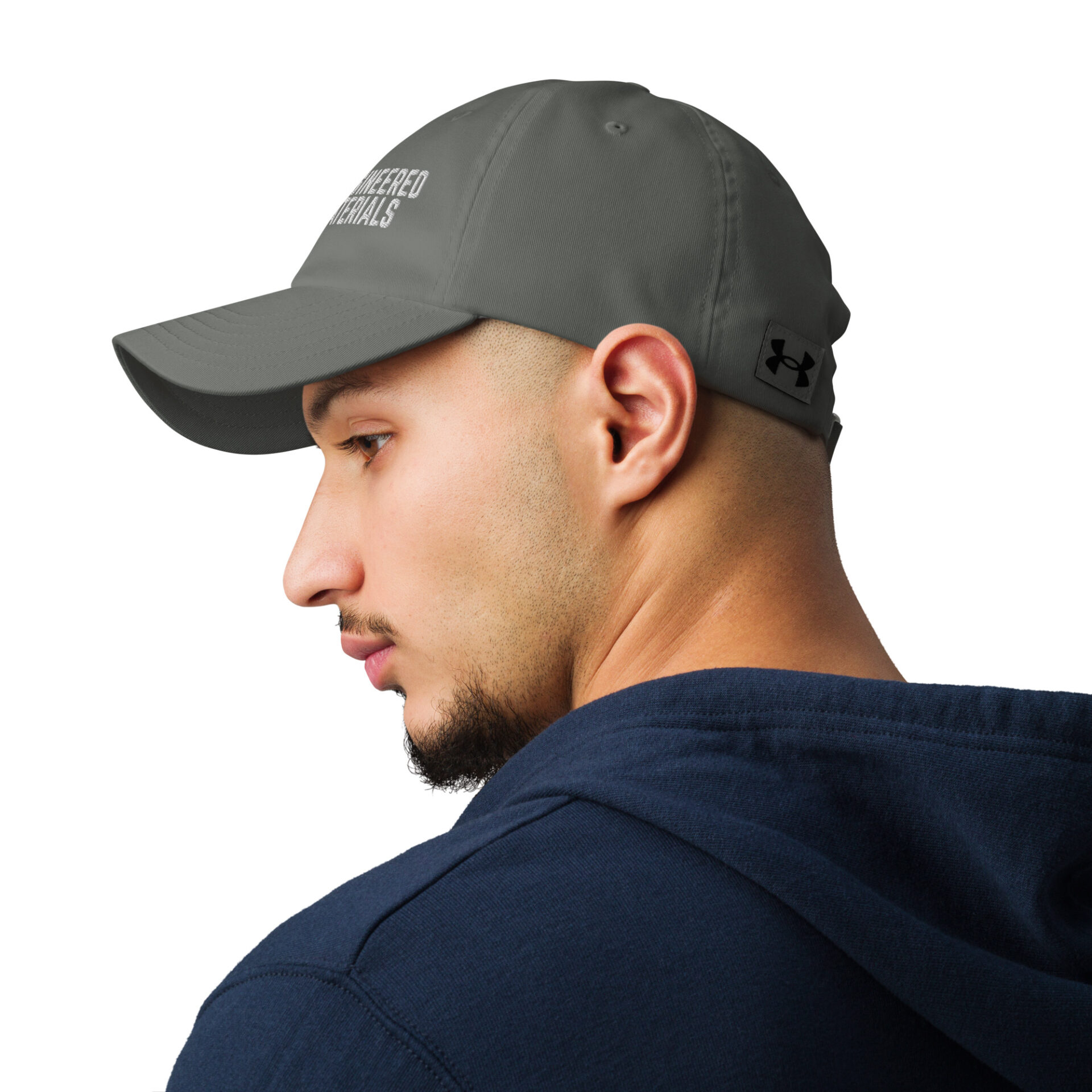 a man wearing a grey under armour baseball cap