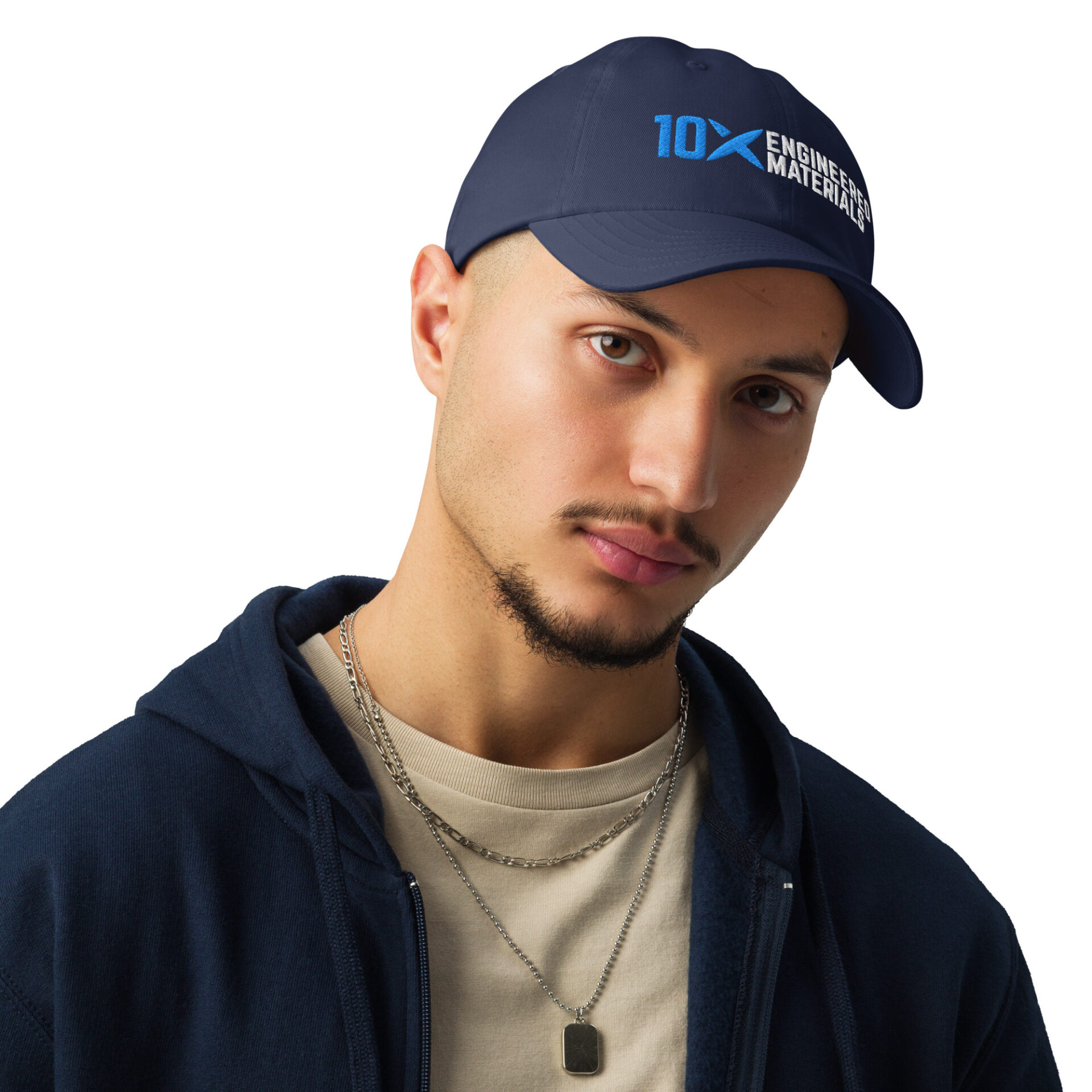 A man wearing a navy blue hat that has the 10X Engineered Materials logo on it