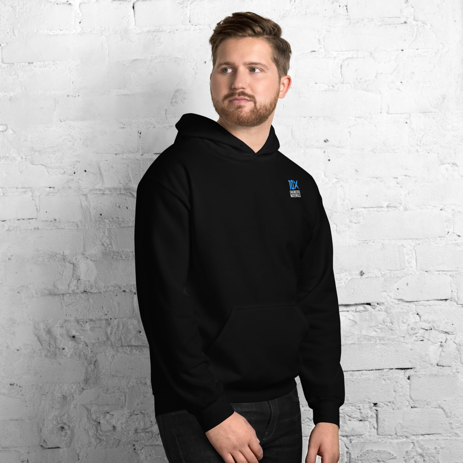 a man wearing a black hoodie that has the 10X Engineered Materials logo on it