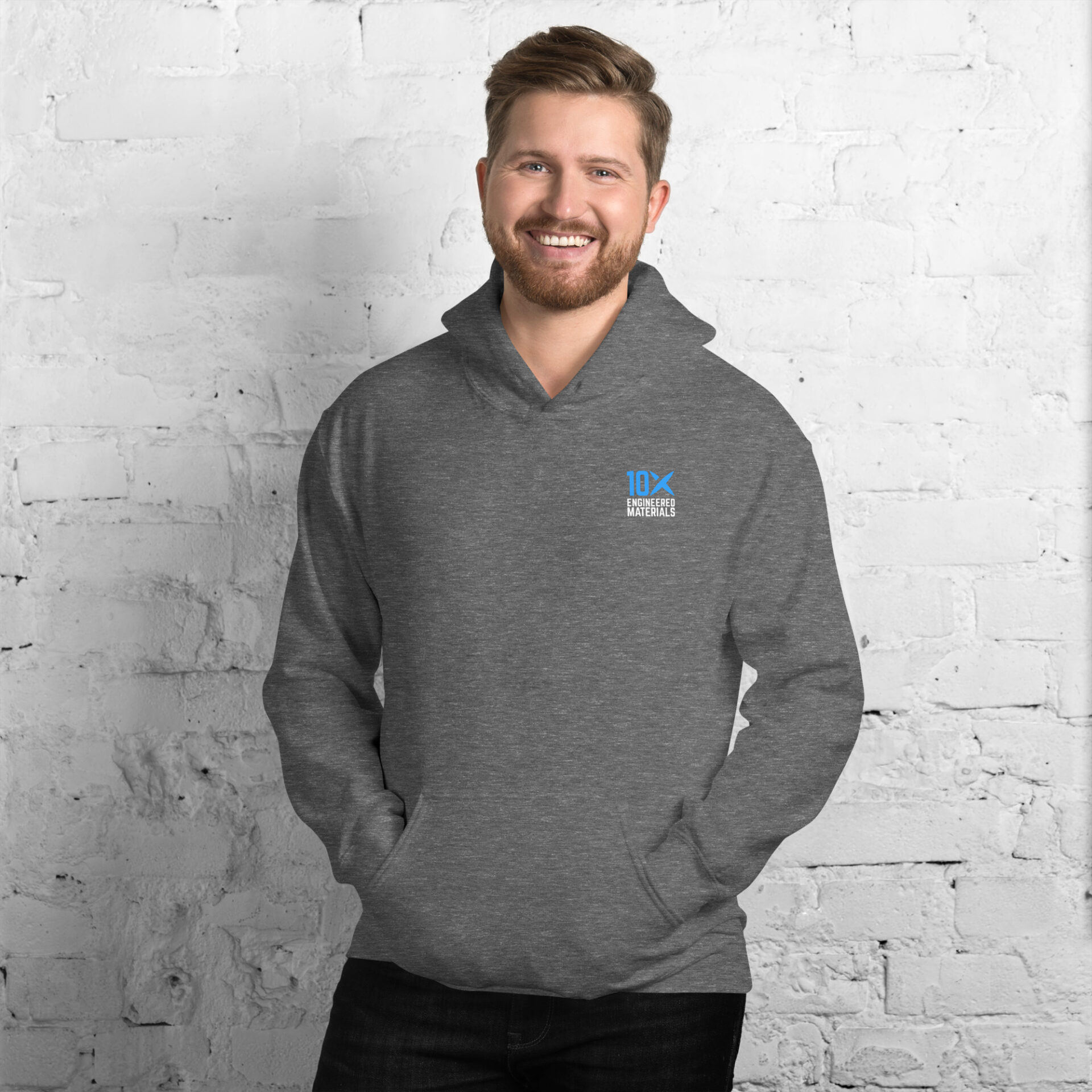a man wearing a grey hoodie that has the 10X Engineered Materials logo on it