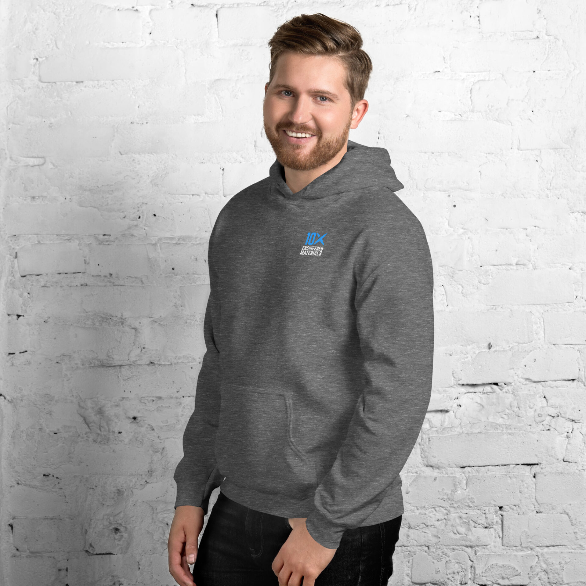 a man wearing a grey hoodie that has the 10X Engineered Materials logo on it