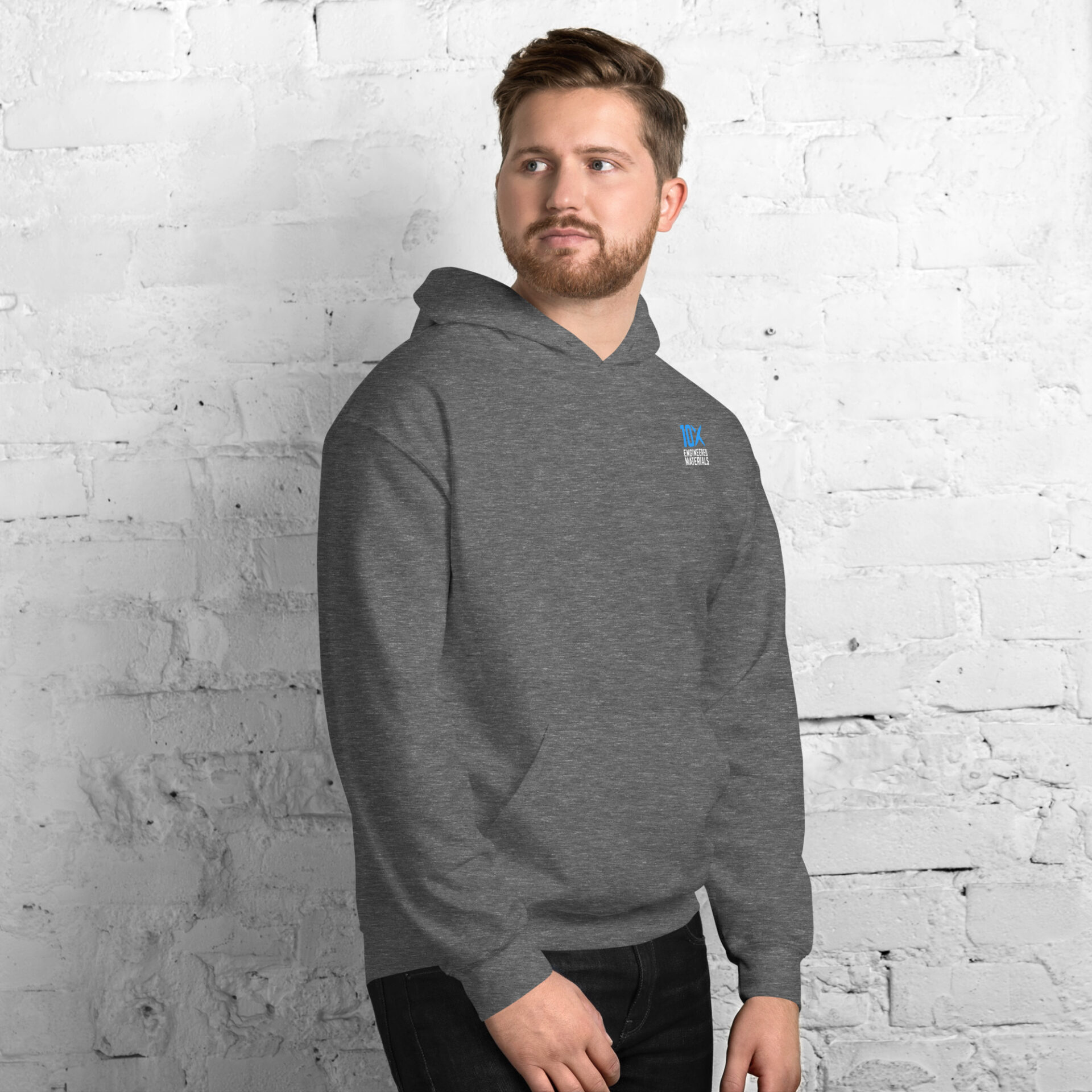 a man wearing a grey hoodie that has the 10X Engineered Materials logo on it
